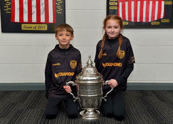 Derry City fans Ben and Shannon Doherty pictured with the FAI Cup at the Ryan McBride Brandywell Stadium on Thursday evening last.