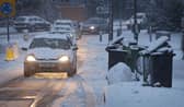 LEATHERHEAD, UNITED KINGDOM - JANUARY 13:  Cars queue past un-emptied rubbish bins on January 13, 2010 near Leatherhead, England. Further snow showers have caused the closure of Gatwick Airport and a number of schools in south east England  (Photo by Peter Macdiarmid/Getty Images)