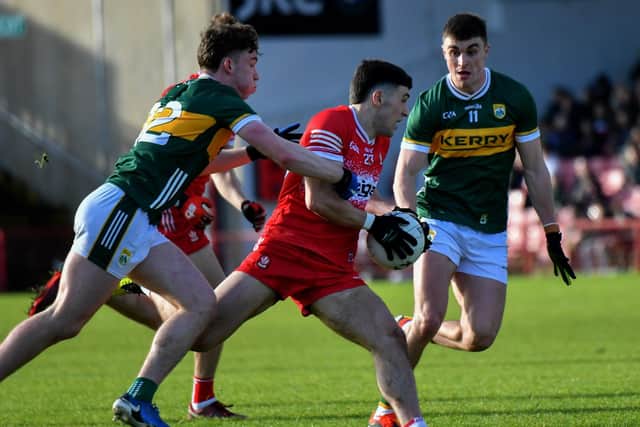 Kerry pair Ruairi Murphy and sean O’Shea close in on Derry’s Ben McCarron. Photo: George Sweeney