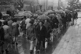 Factory workers walking along the street in Derry.