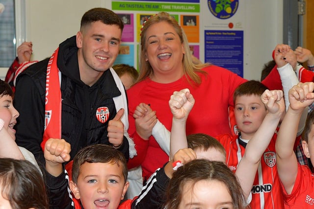Gaelscoil Eadain Mhoir principal Mary nic Ailin and her son Sean pictured with Derry City goalkeeper Brian Maher during a visit to the school on Friday. Photo: George Sweeney  DER2244GS – 25