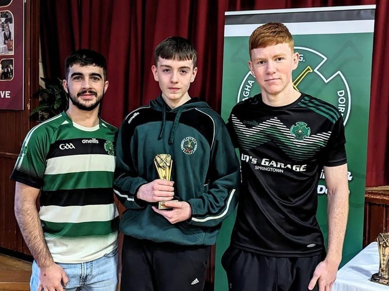 Shea O'Mora receives the U15 Hurlers Most improved award from Daniel Doherty and Keelan Doherty.