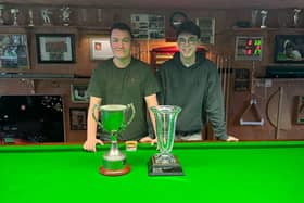Shea Moore (left) shows off the NI Intermediate trophy and St. Patrick's Cup alongside his brother, Ciaran.