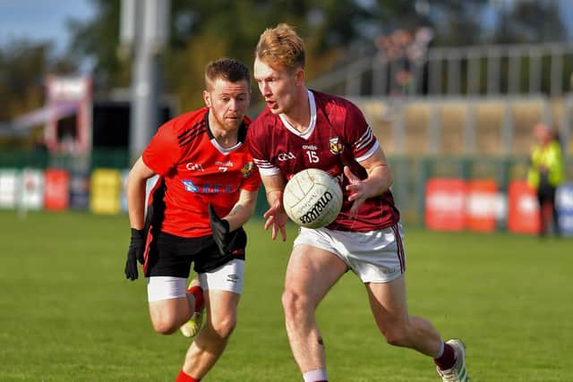 Greenlough’s Matthew Bradley closes in on Banagher’s Tiarnan Moore during Sunday’s IFC semi-final at Owenbeg. Photo: George Sweeney