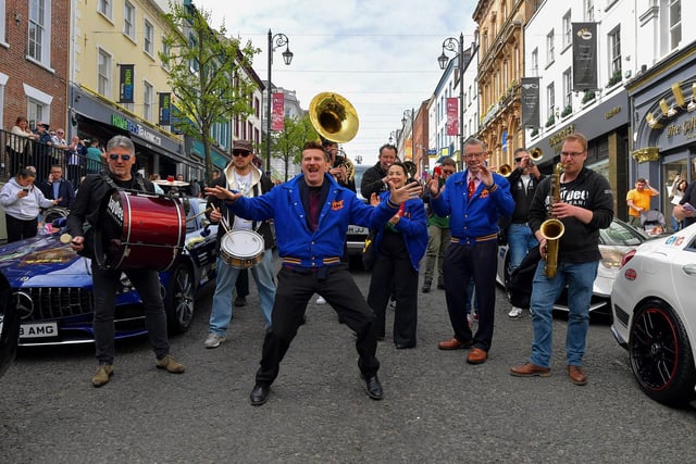 Ian Clarkson jives with members of the Jive Aces and Jaydee Brass Band at the super cars and American Muscle cars Bear Run event on Derry’s Shipquay Street, on Saturday morning, to raise funds for Bumbleance, the Children’s Ambulance Service. Photo: George Sweeney.  DER2317GS – 120
