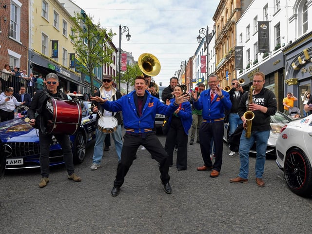 Ian Clarkson jives with members of the Jive Aces and Jaydee Brass Band at the super cars and American Muscle cars Bear Run event on Derry’s Shipquay Street, on Saturday morning, to raise funds for Bumbleance, the Children’s Ambulance Service. Photo: George Sweeney. DER2317GS – 120