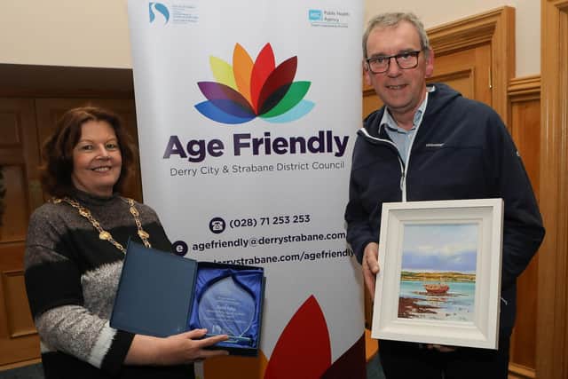 Mayor Patricia Logue makes a presentation to David Fahy, 1st place in the Age Friendly "Your Happy Place" competition. (Photo - Tom Heaney, nwpresspics)