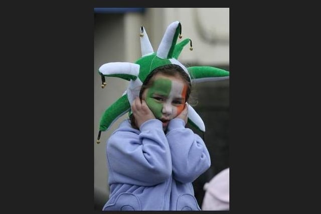 Five years-old Chloe Donnelly, from Burt, covers her ears as passing lorries blow their air horns. (1803C13) St Patrick's Day Buncrana 2005.