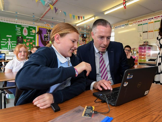 Maeve demonstrates Coding using Microbits to Education Minister Paul Givan during his visit to the Naíscoil Dhoire and Bunscoil Cholmcille, Steelstown, on Wednesday morning. Photo: George Sweeney