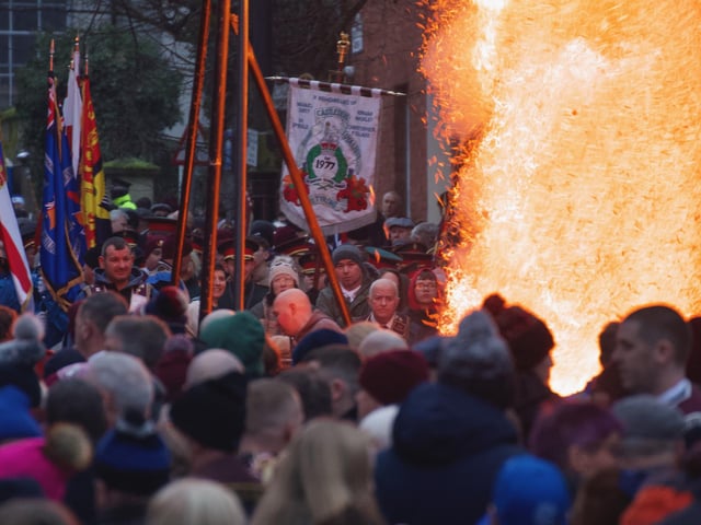 Apprentice Boys and supporters watch as an effigy of Robert Lundy burns in Bishop Street.