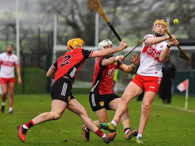 Down pair Matt Conlon and John McManus tackle Derry’s Shea Cassidy last week at Owenbeg. Photo: George Sweeney