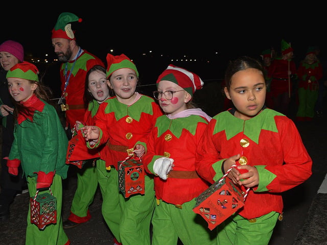 Culmore Community Partnership Elf Parade makes its way towards the Community Hub on Friday night. Photo: George Sweeney