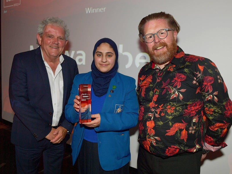 Carer of the Year Award winner Marwa Alberro receives her trophy from Sean McCauley, Optometrist Director, Specsavers Derry, on the right, and compere Adrian Logan. Photo: George Sweeney. DER2325GS – 46