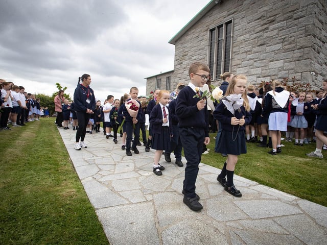 Some of the younger pupils make their way up to law flowers at the St. Mary's Church Grotton. (Photos: Jim McCafferty Photography)