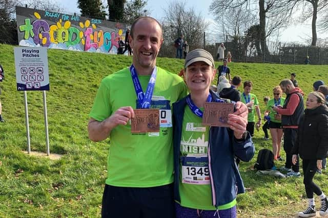 Mark Durkan and a fellow runner with a medal following completion of the race on Saturday.