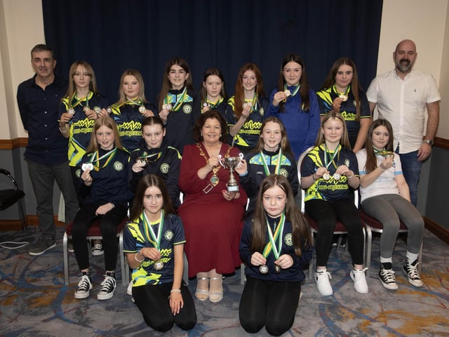 The Mayor of Derry City and Strabane District Council, Patricia Logue presenting the Winter Cup to Sion Swifts Flames u-12s.. Included are coaches Mark Patton and Gerard Tourish.