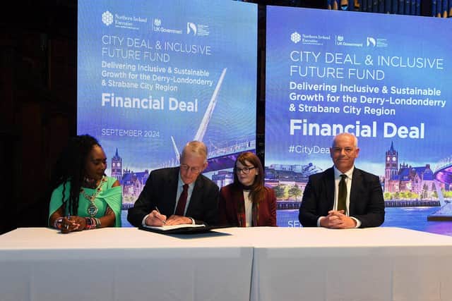 Mayor Lilian Seenoi Bar, NI Secretary of State Hilary Benn MP, Dr Caoimhe Archibald, Finance Minister and DSCDC Chief Executive Joh Kelpie sign the Financial Deal for Derry and Strabane region at the Guildhall on Wednesday morning. Photo: George Sweeney
