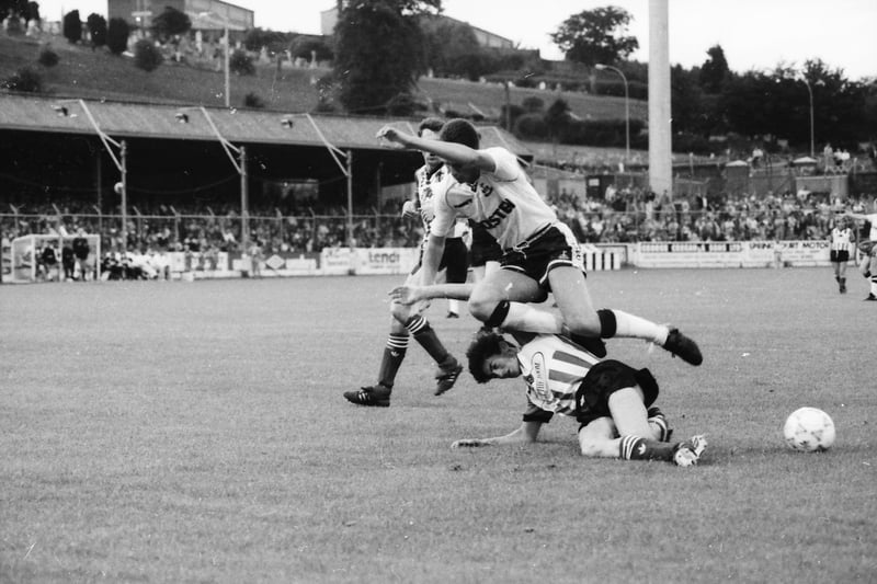 Peter 'Pizza' Hutton clears ball and all.