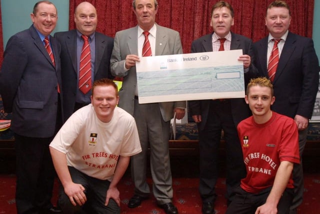 Johnny Kelly (second from right) of the Fir Trees Hotel, presenting a cheque ot Felix McCrossan, treasurer of Tyrone Milk Cup committee for sponsorship of this years Milk Cup squad.  Also in photo are Sean Curneen, Chairman Tyrone Milk Cup committee, Danny Rouse Manager of Strabane FC and Marty Gamble. at front are squad members James McAnenny and Darren Gamble.  (0402JB01)