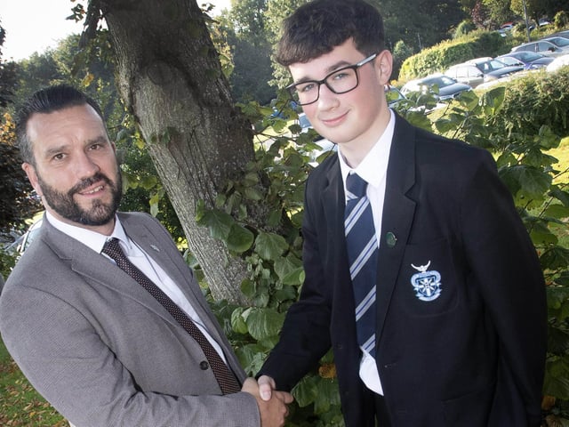 St. Columb's College 12H Academic Prizewinner (Student achieving at least 7 + A*/A at GCSE) Rhys Fallon being congratulated by form tutor Mr. McQuillan on Friday morning last. (Photos: Jim McCafferty Photography)