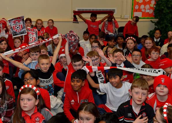 Pupils from Good Shepherd Primary School gave a rapturous welcome to Derry City players Mark Connolly, Liam Mullan and Jack Lemoignan during a visit to the school, with the FAI Cup, on Friday afternoon. Photo: George Sweeney. DER2247GS – 97