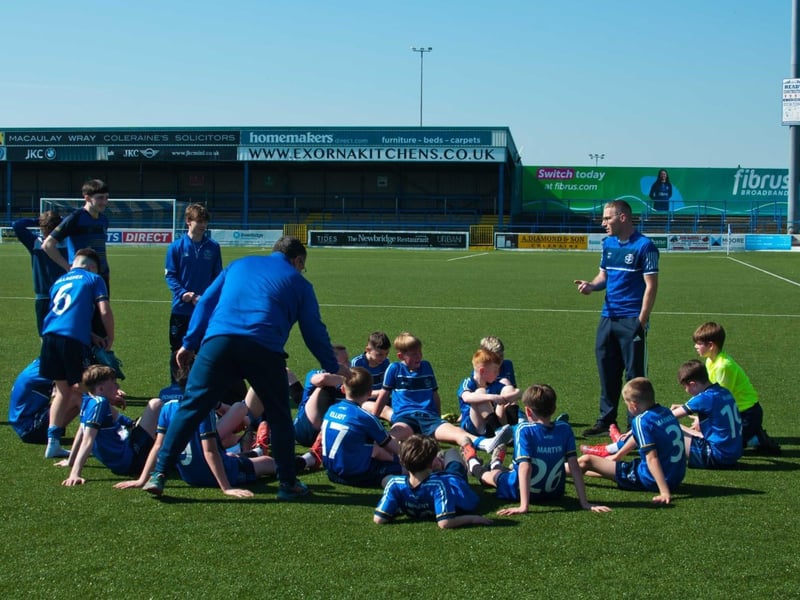 Coaches give their half-time teamtalk with St Columb's in the driving seat at 1-0.