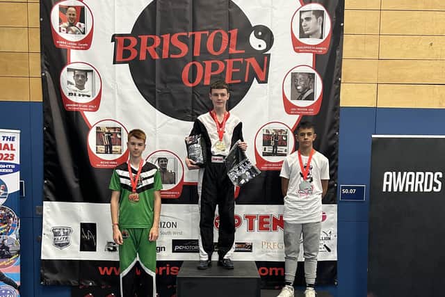 Derry's Kyle Moore (centre) receives his gold in the U15 individual -63kg category at the recent Bristol Open.