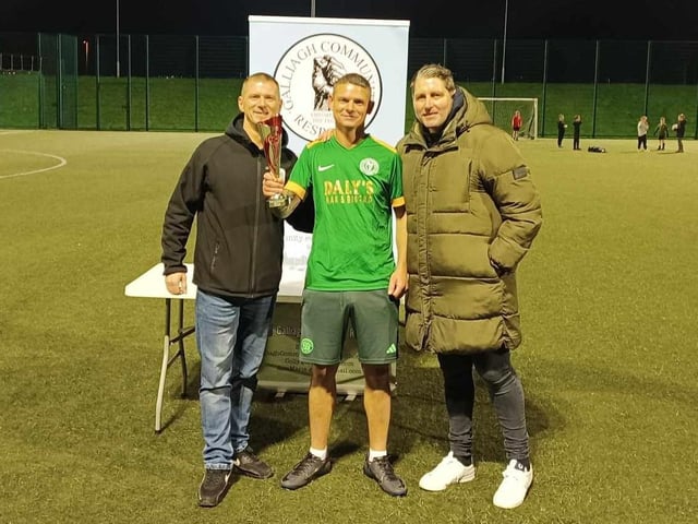Mickey Deery collecting the GCR Memorial Cup from Derry City Manager Ruaidhrí Higgins. Colly McLaughlin of GCR is also pictured.