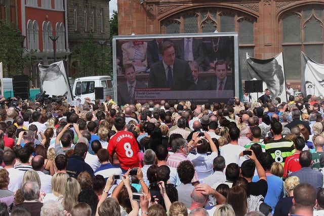 The gathered crowd at Guildhall Square listen to the British Prime Minister David Cameron, addressing the House of Parliment on the Lord Saville Report on 'Bloody Sunday'. LS2410-515MT.