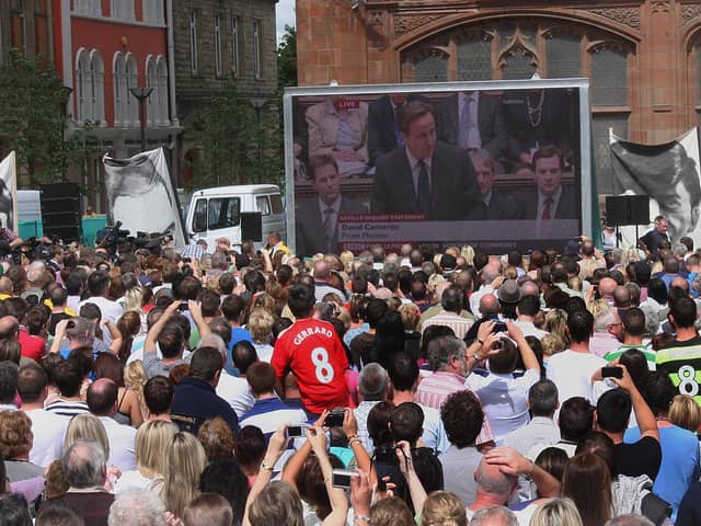 The gathered crowd at Guildhall Square listen to the British Prime Minister David Cameron, addressing the House of Parliment on the Lord Saville Report on 'Bloody Sunday'. LS2410-515MT.