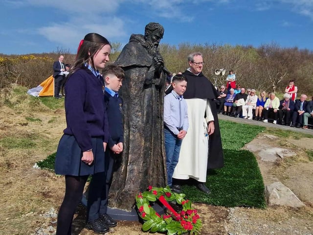 Father Damian Polly OP Dominican Friar with local schoolchildren after the Laying of the Wreath.
