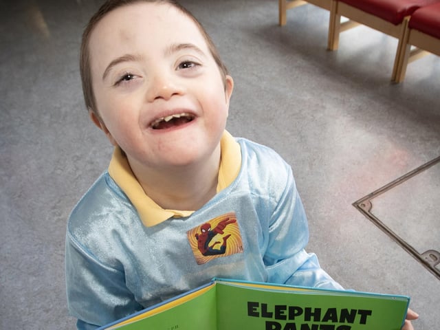A fantastic smile from P3 pupil Callum as he enjoys his very funny book.