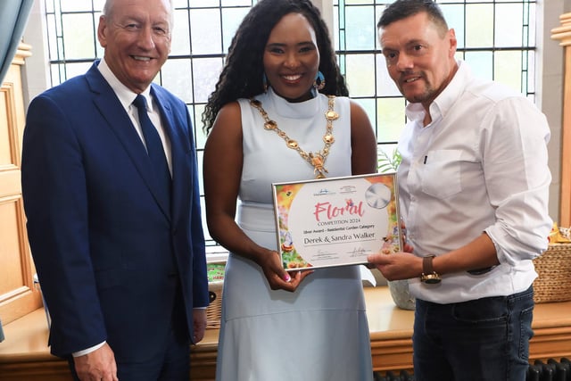 Mayor Lilian Seenoi Barr presents the City Centre Initiative Floral Competition 2024 Silver Award (Residential Garden Category) to Derek Walker. Included on the left is Jim Roddy, CEO of City Centre Initiative. (Photo - Tom Heaney, nwpresspics)