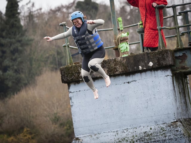 BRAVE JUMP!. . . .St. Joseph’s Boys School teacher Fiona Page jumps off the pier on Saturday.
