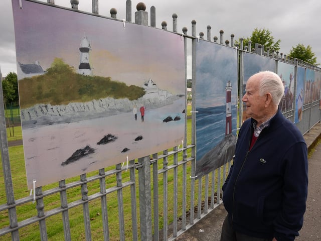 Talented artist Andre Doherty with one of the paintings on display.