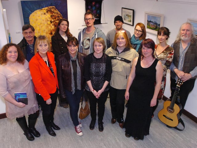 Judi Logue, centre, from Eden Place Arts Centre, with Inishowen Rural Arts Network artists launching their exhibition 'Borderlands' at Pilot's Row. Included, front from left, are Kathryn Daily, Mary Doherty, Evelyn Doherty, Audrey Doherty and Darlene Corry. Back row, from left, Pascal Thomas, Tanya McColgan, Andy Smith, Jes McSparron, Orna Doherty, Sinead Smyth and Seoirse O'Doherty. (DER4613PG078)