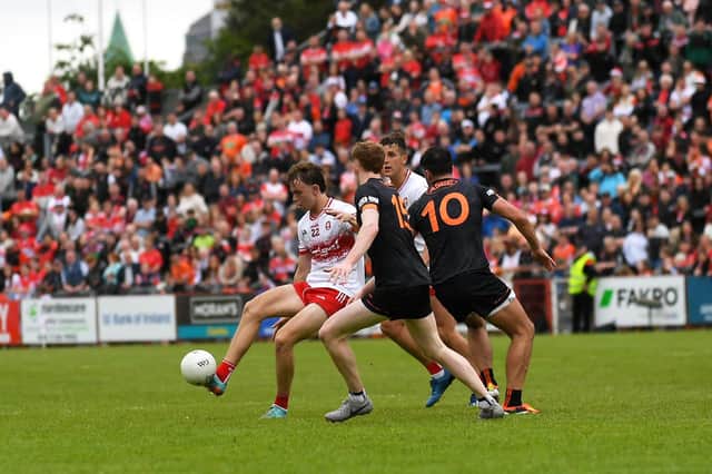 Derry’s Donncha Gilmore off loads the ball under pressure. Photo: George Sweeney