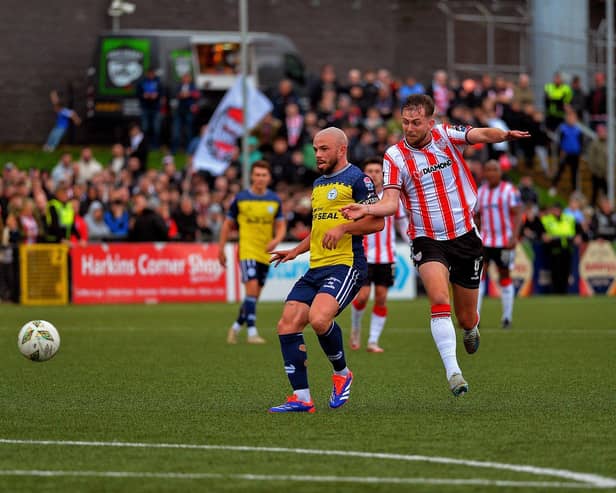 Derry City’s Will Patching and Shelbourne’s Mark Coyle contest a loose ball.  Photograph: George Sweeney