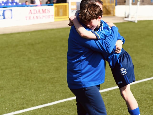A special moment captured as coach Xavier Prigent embraces his son Tom who played a key role in the final.