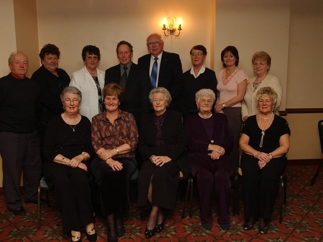 Members of the Moville Day Centre committee pictured at their Christmas Dinner at McNamara's Hotel. Included, seated from left, Nan McCarron, Brigid McGuinness, Marmie Gillespie, chairperson, Brigid McLaughlin, and Eileen Kelly. Standing, from left, Tony Gillespie, Mary McNally, Kathleen Cavanagh, Patsy McDermott, Thomas Doherty, Nuala McLaughlin, Claire McGuinness, and Annie McDermott. (0912PG40) :Christmas parties for Derry's senior citizens in December 2003