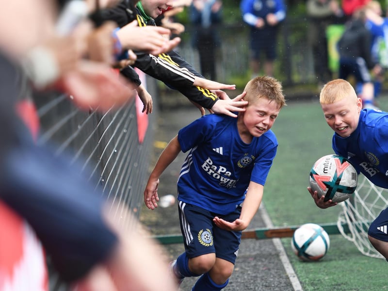 Shankill Juniors players Joel Greenaway and Riley Black celebrate with supporters. (Photo Keith Moore)