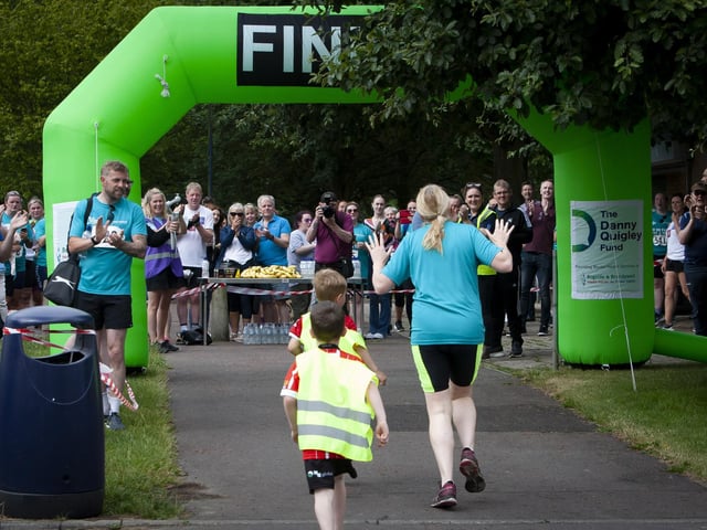 A rapturous reception for this mum who crosses the finish line accompanied by her two sons at Sunday’s BBHF ‘Try-A-Tri’. (Photos: Jim McCafferty Photography)