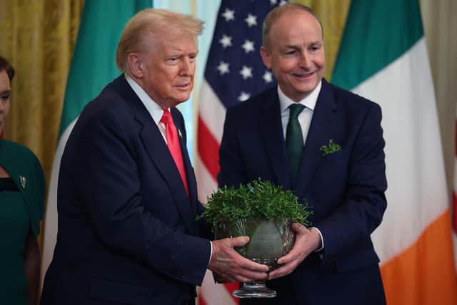 WASHINGTON, DC - MARCH 12:  Irish Taoiseach Micheál Martin presents U.S President Donald Trump with a bowl of clover during a St. Patrick’s Day event in the East Room of the White House on March 12, 2025 in Washington, DC. Martin traveled to the United States for the Irish leader's annual St. Patrick's Day visit where he attended a luncheon with Congressional leaders and a meeting in the Oval Office with Trump.  (Photo by Kayla Bartkowski/Getty Images)