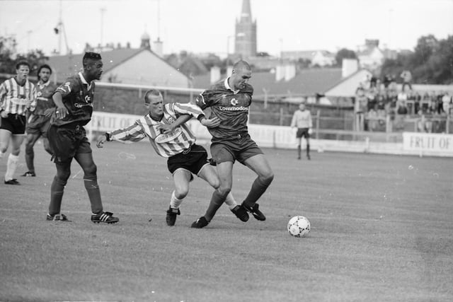 Vinnie Jones shields the ball from Gregory Kearney.