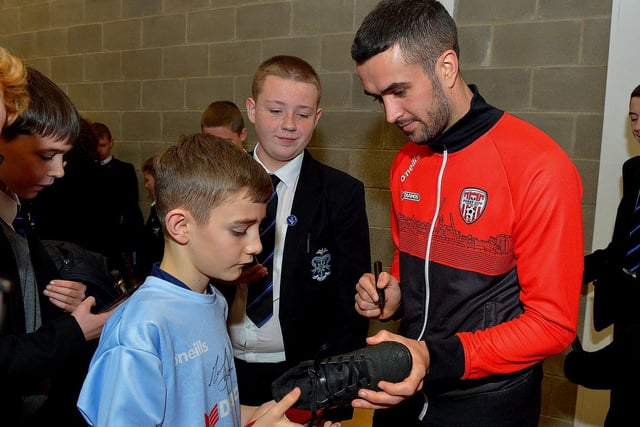 Derry City's Michael Duffy signs autographs for pupils during a visit to the school with the FAI Cup, on Monday . Photo: George Sweeney. DER2247GS  27