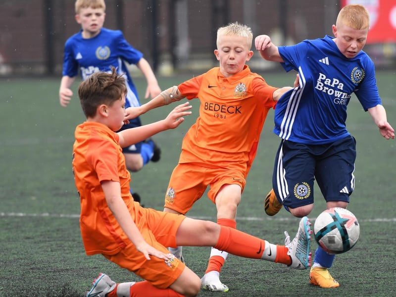 Shankill Youths forward Riley Black evades Glenavon defenders Callum Quinn and Ben Lamont during their O'Neills Foyle Cup Under-11's final at the Bishop's Field.