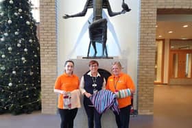 Altnagelvin Hospital Dementia Companions Madeline Pena Hernandez and Sharon McKittrick accepting donations gifted to the hospital for patients with a diagnosis of Dementia. Handing over the donations is Wendy Doherty, Volunteer and Work Experience Coordinator (centre).