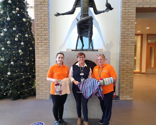 Altnagelvin Hospital Dementia Companions Madeline Pena Hernandez and Sharon McKittrick accepting donations gifted to the hospital for patients with a diagnosis of Dementia. Handing over the donations is Wendy Doherty, Volunteer and Work Experience Coordinator (centre).