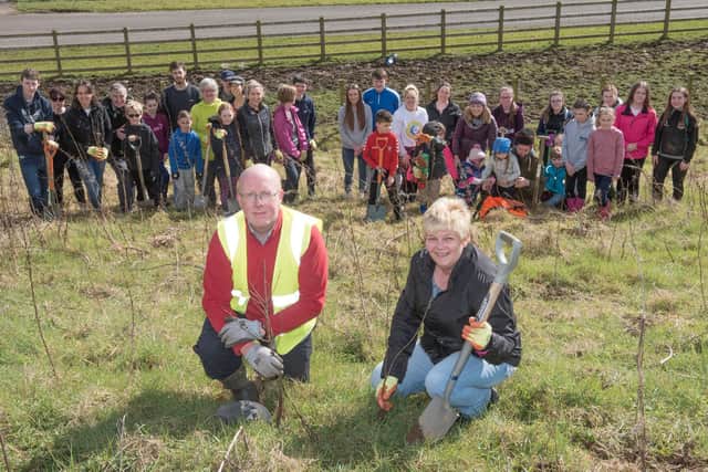 2018: Councillor Angela Dobbins, Environment and Regeneration Committee Chair and Michael Savage, Derry City and Strabane District Council pictured with volunteers who planted over 500 trees on Saturday morning alongside the Culmore Road / Madams Bank Road to provide a better visual screen for the Boom Hall lands and filter air & noise pollution in the area, Picture Martin McKeown. Inpresspics.com. 24.03.18