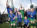 BACK-TO-BACK CHAMPIONS!. . . ..The triumphant Destined FC players celebrate winning Friday's FDST Peace Games tournament at the Shared Village Centre, Waterside.